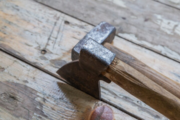 old work tools worker ax and hammer on the background of boards