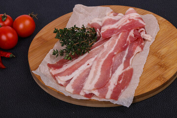 Raw bacon on the board