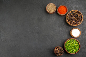 top view different seasonings with greens on grey background color photo food spicy pepper
