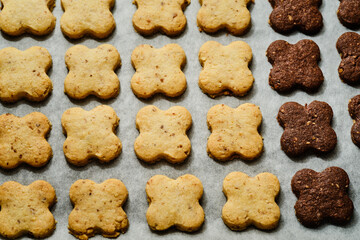 Tasty four leaf clover sweets on baking tray
