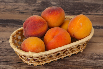 Peach heap in the wooden basket