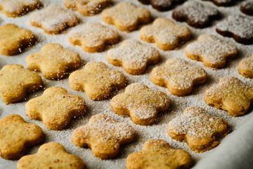 Tasty four leaf clover sweets on baking tray