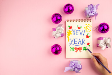 top view cute little presents with xmas tree toys and new year note on pink background gift color new year christmas photo