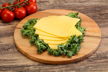 Sliced Gauda cheese over board