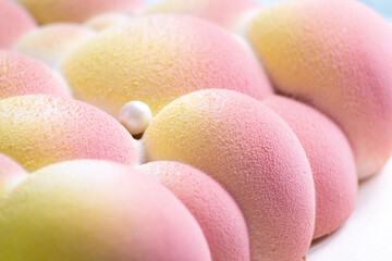 Mousse cake with Coffee, banana and milk chocolate velvet white bubble coating, close up
