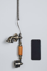 
Old vintage phone next to a latest generation mobile on white background
