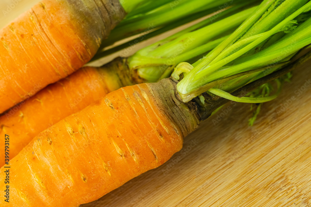 Wall mural appetizing fresh carrots orange root vegetables with green tops