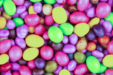 Fototapeta na wymiar colorful background candy jelly beans yellow, pink and green bright pattern