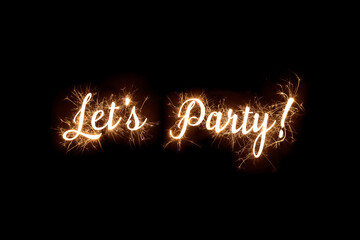 Cursive word of 'Lets Party' in dazzling sparkler effect on dark background