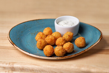 Potato croquettes - mashed potatoes balls breaded and deep fried, served with different sauce.