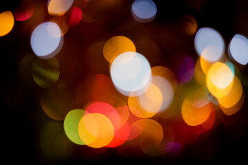 Fototapeta premium Christmas lights colorful bokeh background. Holiday festive atmosphere