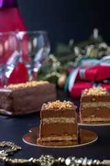 Sliced mousse desserts with hazelnut praline, milk chocolate and covered gourmet chocolate-nut glaze on new year background. Close-up. Vertical format