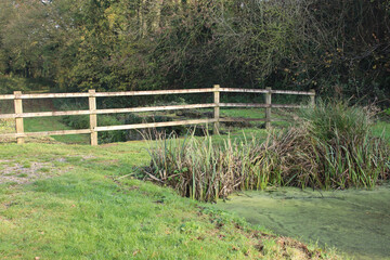 A wooden fence at the end of the Grand Western canal at Lowdwell lock in Somerset