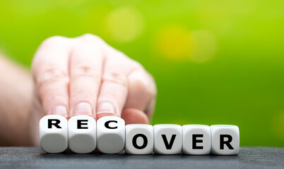 Hand turns dice and changes the word over to recover.