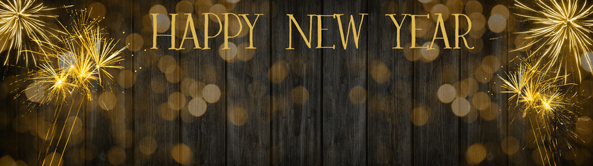 Happy New Year - Silvester background banner panorama long- Golden firework and bokeh lights on rustic black wooden texture, with space for text