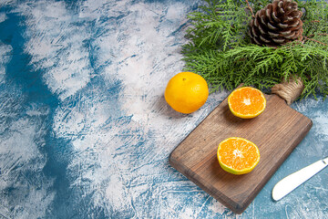 front view fresh tangerine slices on light-blue background citrus fruit tree color juice photo