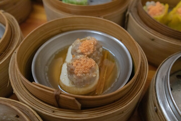 close up of variety dim sum in bamboo basket