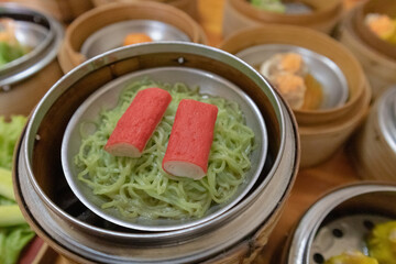 close up of variety dim sum in bamboo basket