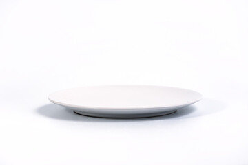 Empty White plate isolated on white background side view, selective focus