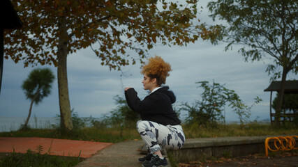 Fit young woman exercising and jumping in park