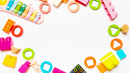 Baby toys frame on a white background. View from above. Flat lay. Copy space for text