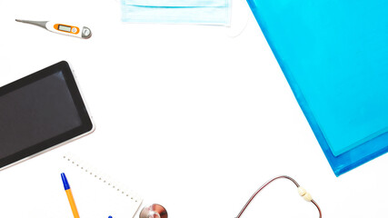 medical folder and blank paper with a pen with a stethoscope on a white background. Copy space. Flat lay. basic doctor's items in hospital.