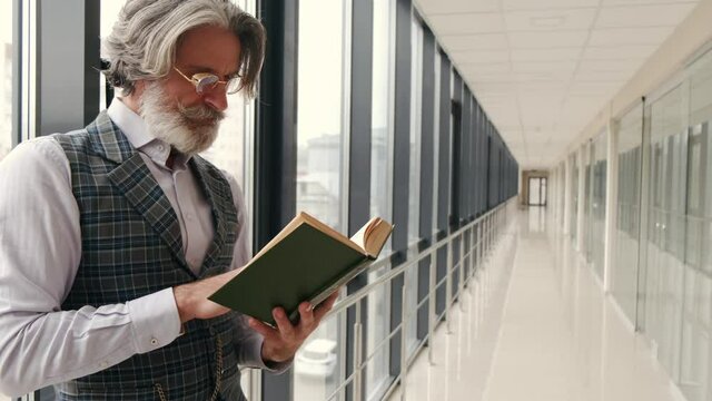 businessman working in book laptop job work  business businessman entrepreneur work books laptop remote work quarantine corona quarantine masks reading book senior office people read portrait old pers