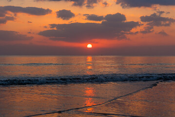 Fototapeta premium Amazing sunset over the ocean. Beautiful clouds and sun. Bright colors. 