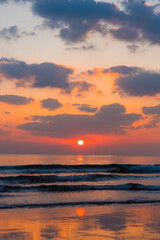 Amazing sunset over the ocean. Beautiful clouds and sun. Bright colors. 