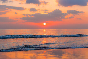Amazing sunset over the ocean. Beautiful clouds and sun. Bright colors. 