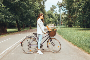 Business elegant woman riding a bicycle in nature.
