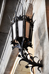 Metal forged lantern. Metal lantern on the wall of an old building.