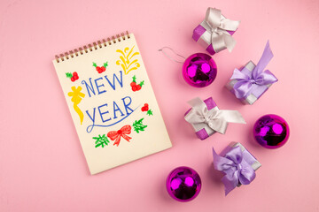 top view little presents with xmas tree toys on a pink background photo color new year christmas gift family