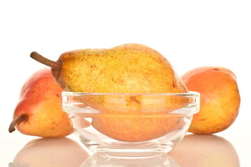 Three sweet red pears with glassware, close-up, on a white background.