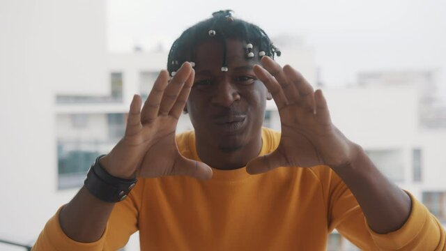 Excited african american man shouting WOW using his hands to amplify his voice. High quality 4k footage
