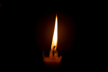 burning candle in the dark