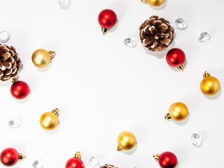 Creative composition made of baubles, Christmas decorations with pine cone and crystals with copy space, flat lay, top view