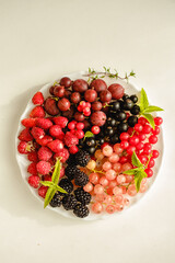 Assorted fresh summer berries. Raspberries, gooseberries, blackberries, currants, wild strawberries, strawberries.