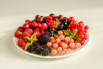 Assorted fresh summer berries. Raspberries, gooseberries, blackberries, currants, wild strawberries, strawberries.