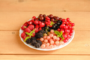 Assorted fresh summer berries. Raspberries, gooseberries, blackberries, currants, wild strawberries, strawberries.