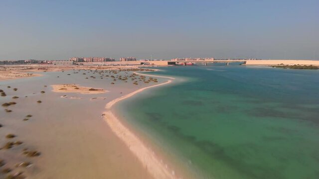 Sandy coastline Bridge and Middle Eastern city in the background, Drone Aerial