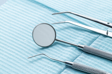 A group of dental instruments on a blue dental napkin