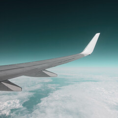 The wing of an airplane in a pure day sky