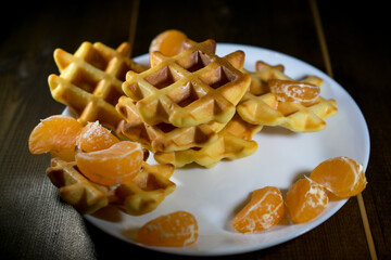 waffles with tangerines on a white plate