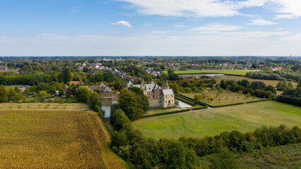 Aerial view of a castle with a moat, surrounded by agriculture fields - in Laarne, Belgium