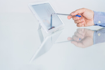 Man pointing to a profit table on the tablet with a pen