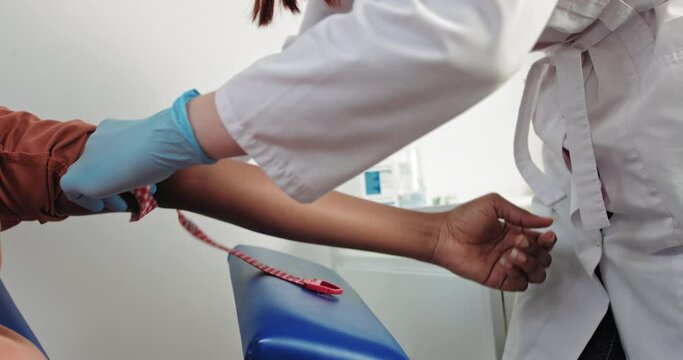 laboratory in clinic. Female lab assistant taking venous blood for test. Healthcare concept. Laboratory in clinic. Female doctor take blood sample from patient to test for coronavirus in hospital