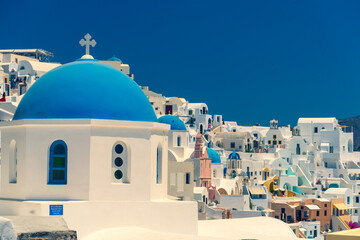 Church of Santorini. Fira town on Santorini island, Greece. Incredibly romantic view on Santorini. Oia village in the morning light. Amazing sunrise view with white houses. Island lovers
