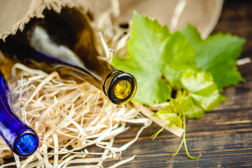 Fototapeta premium Wine bottle on a wooden background. Winemaking, sommelier.