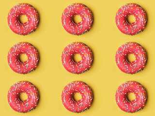 pink donuts with icing on yellow background